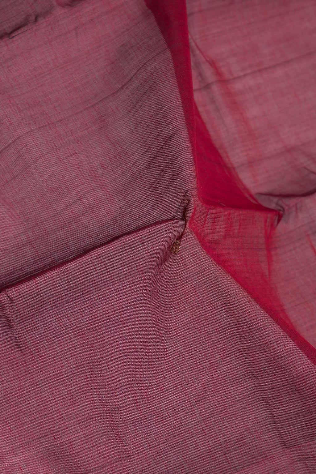 Close up of Maroon Kanchi Cotton Saree with Zari Butta on the body and Zari Border.  displaying folds