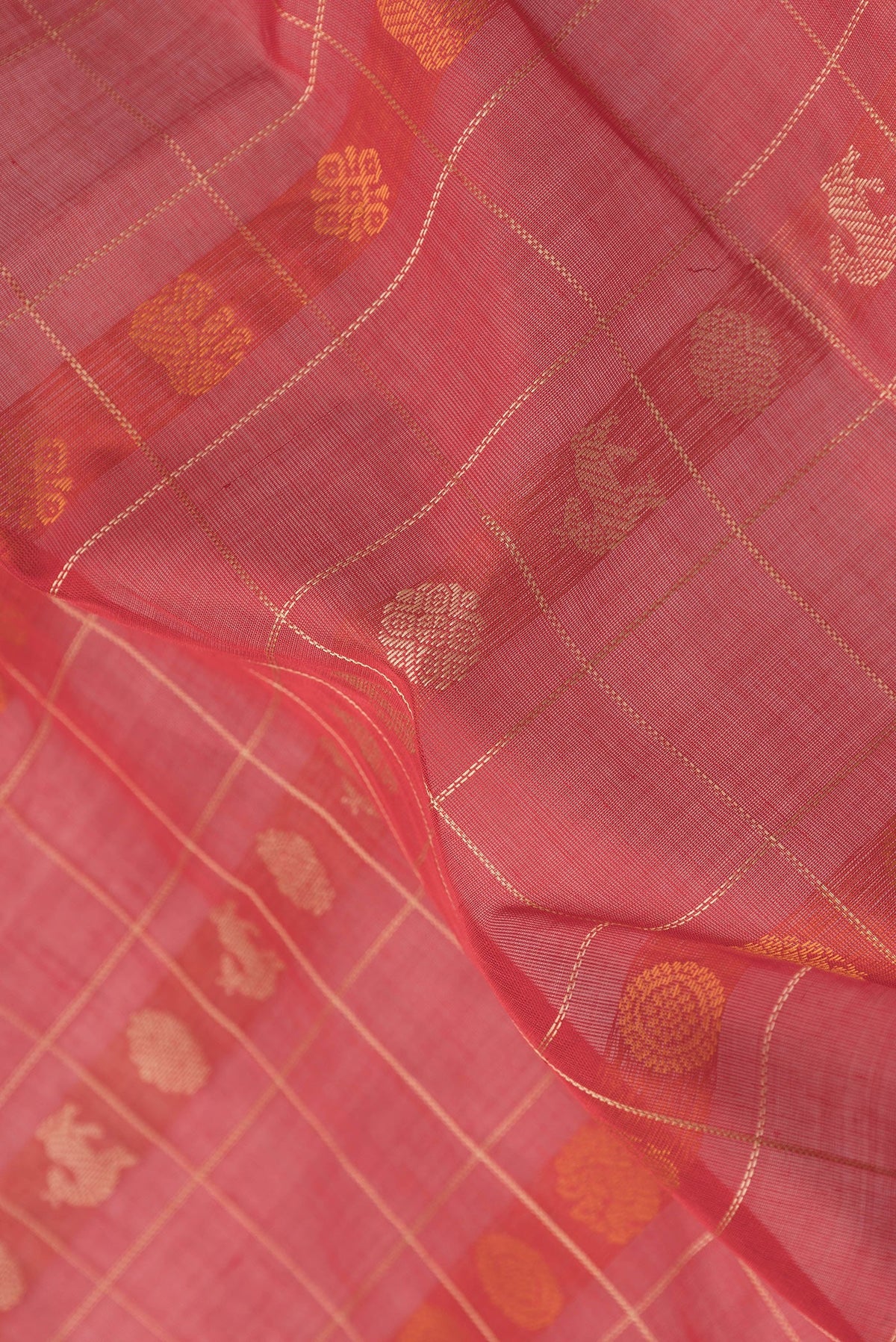Close up of Red Silk Cotton Saree with Checked design on the body and Zari Border.  displaying folds
