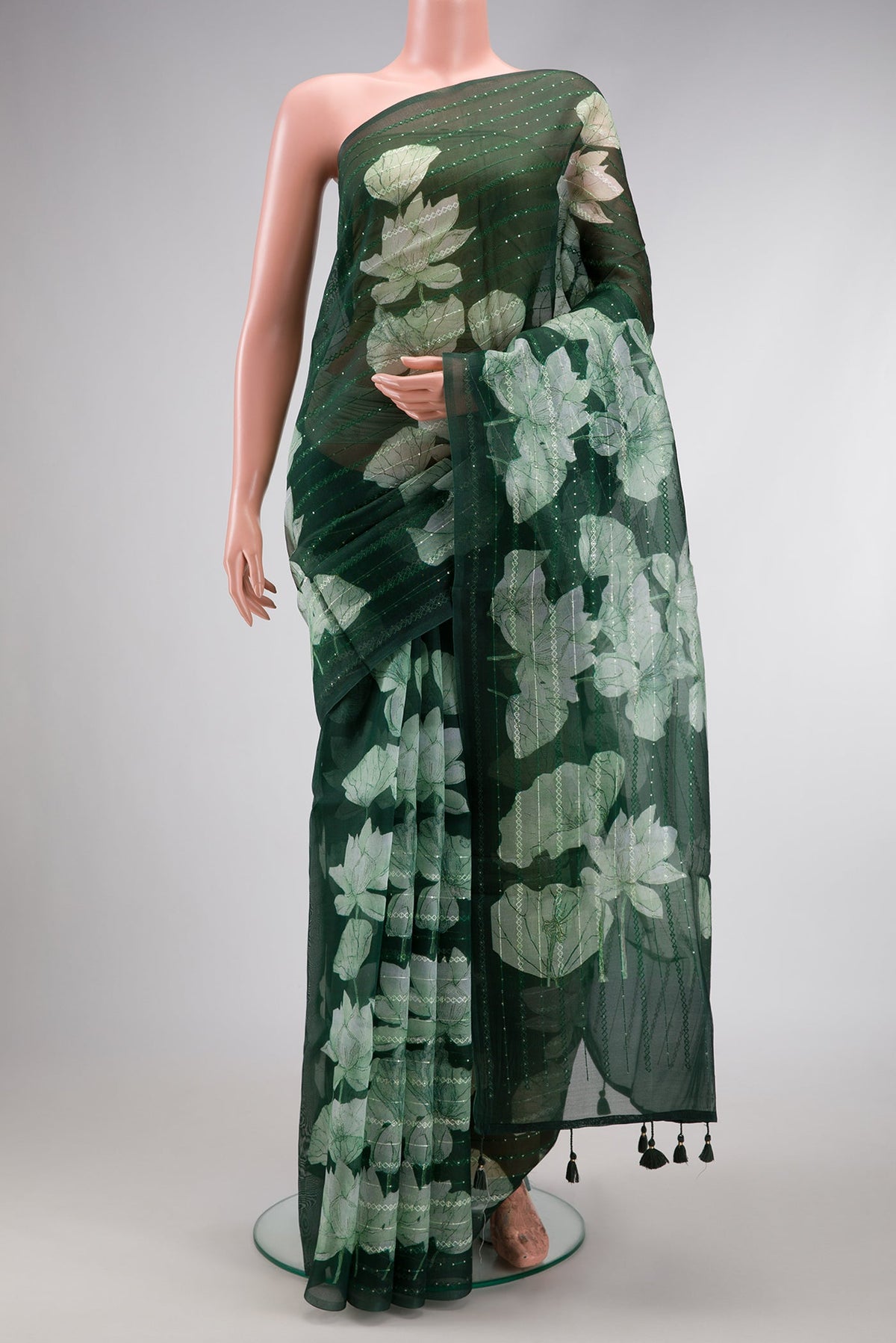 Bottle Green Dual Tone Organza Silk Saree with Embroidery on the body and Without Border.  displayed on a mannequin