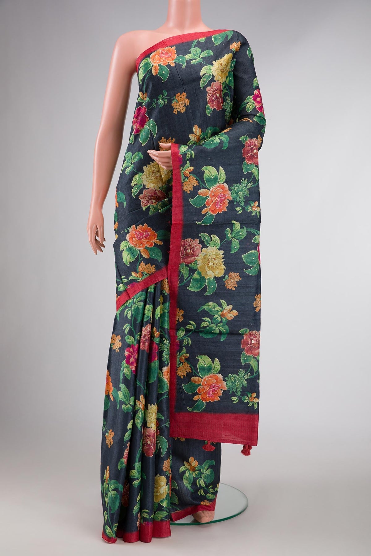 Navy Blue Dual Tone Tussar Silk Saree with Printed design on the body and Zari Border displayed on a mannequin