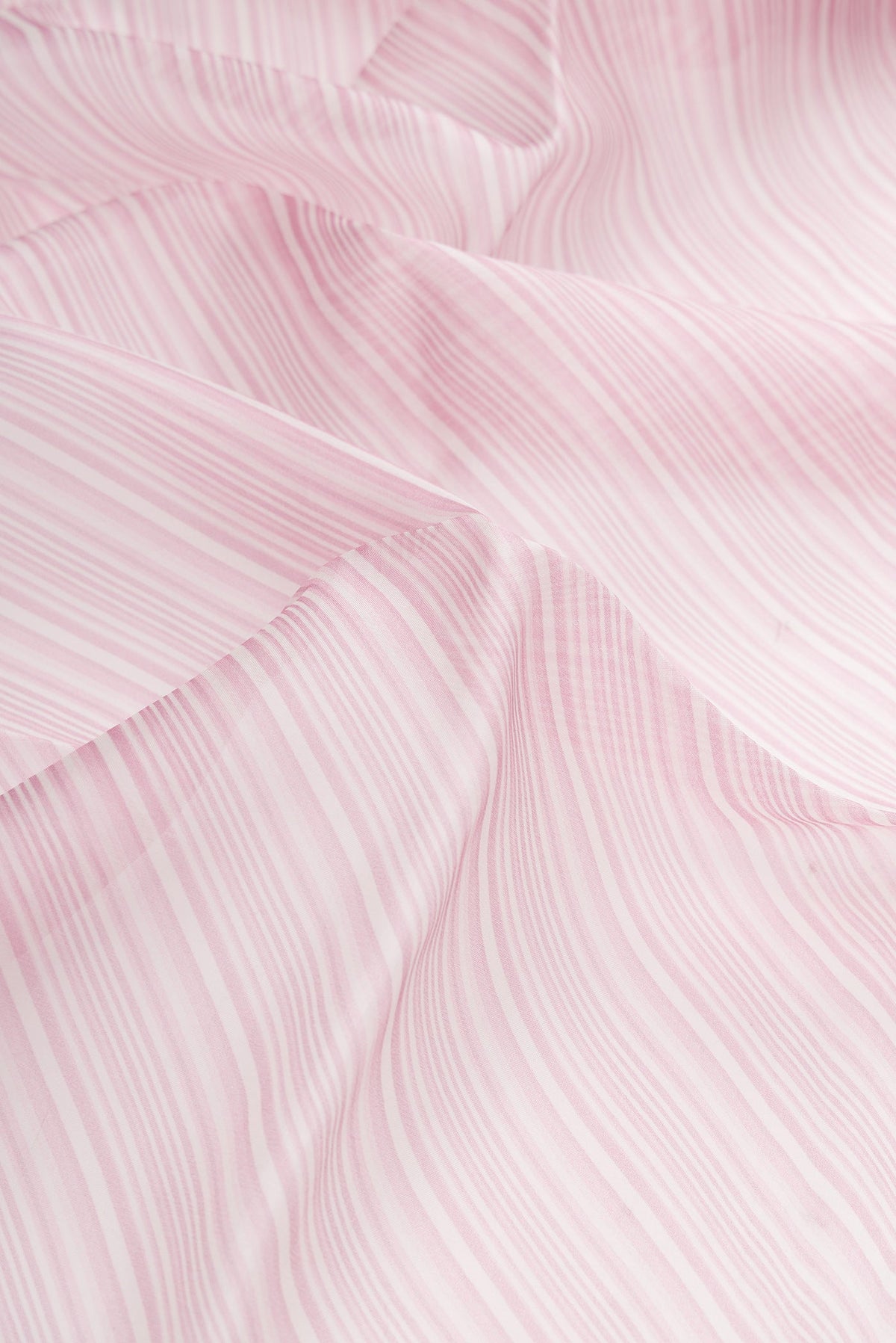 Close up of Lavender Dual Tone Organza Silk Saree with Printed design on the body and Embroidery Border.  displaying folds