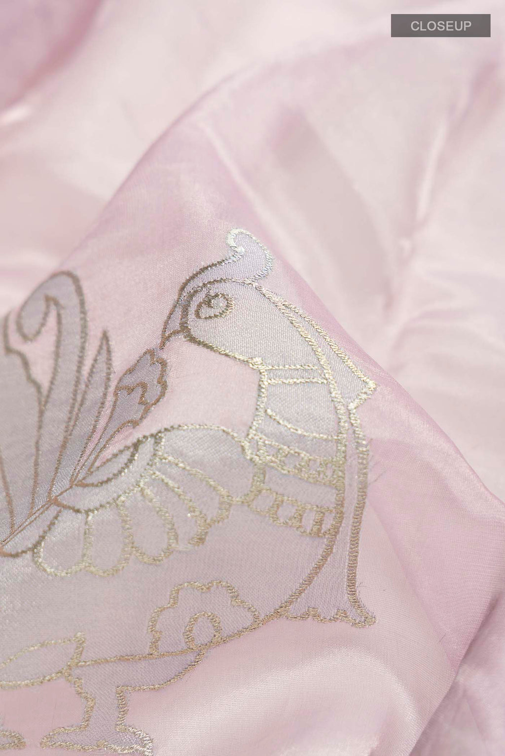 Close up of Lavender Organza Silk Saree with Embroidery on the body and Embroidery Border displaying folds
