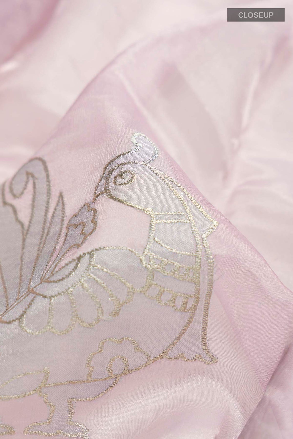 Close up of Lavender Organza Silk Saree with Embroidery on the body and Embroidery Border displaying folds