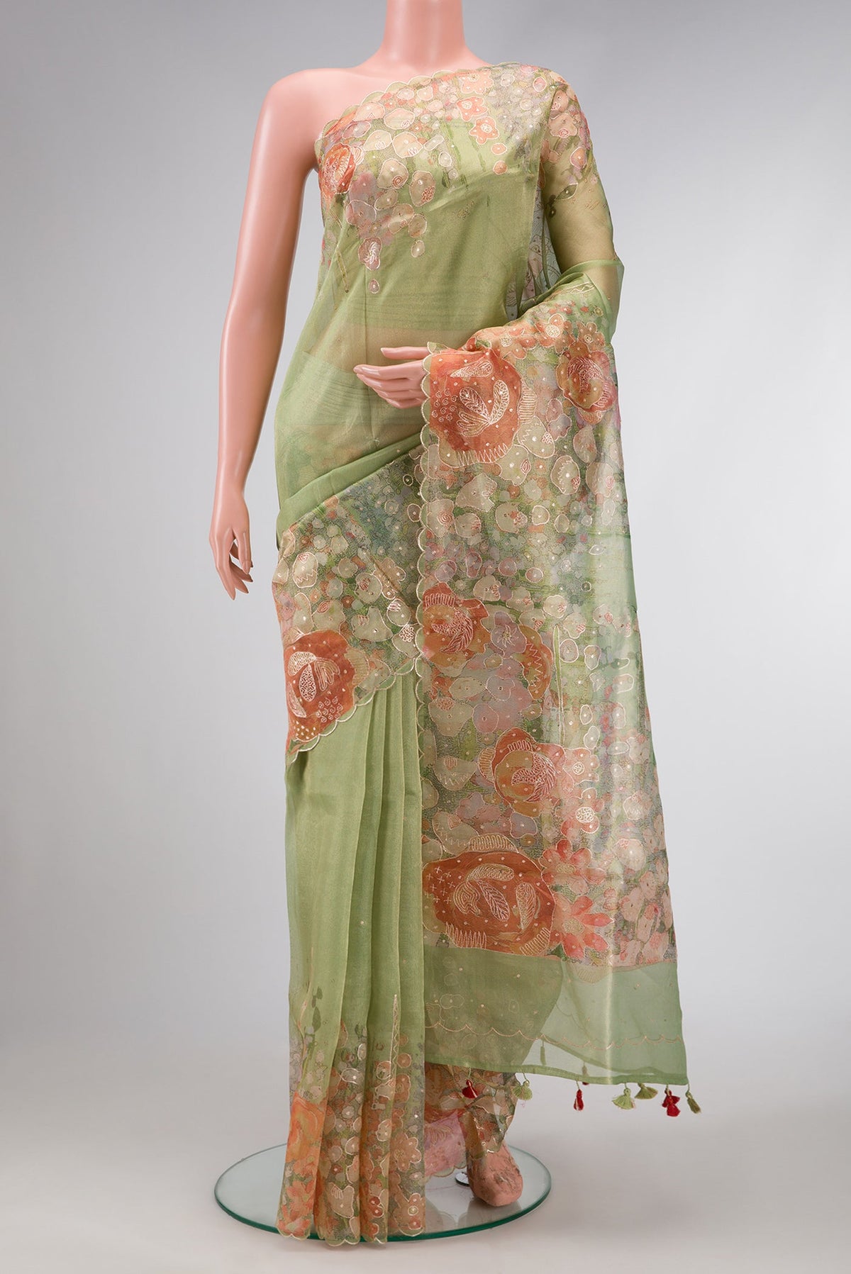 Pista Green Dual Tone Organza Silk Saree with Embroidery on the body and Embroidery Border.  displayed on a mannequin