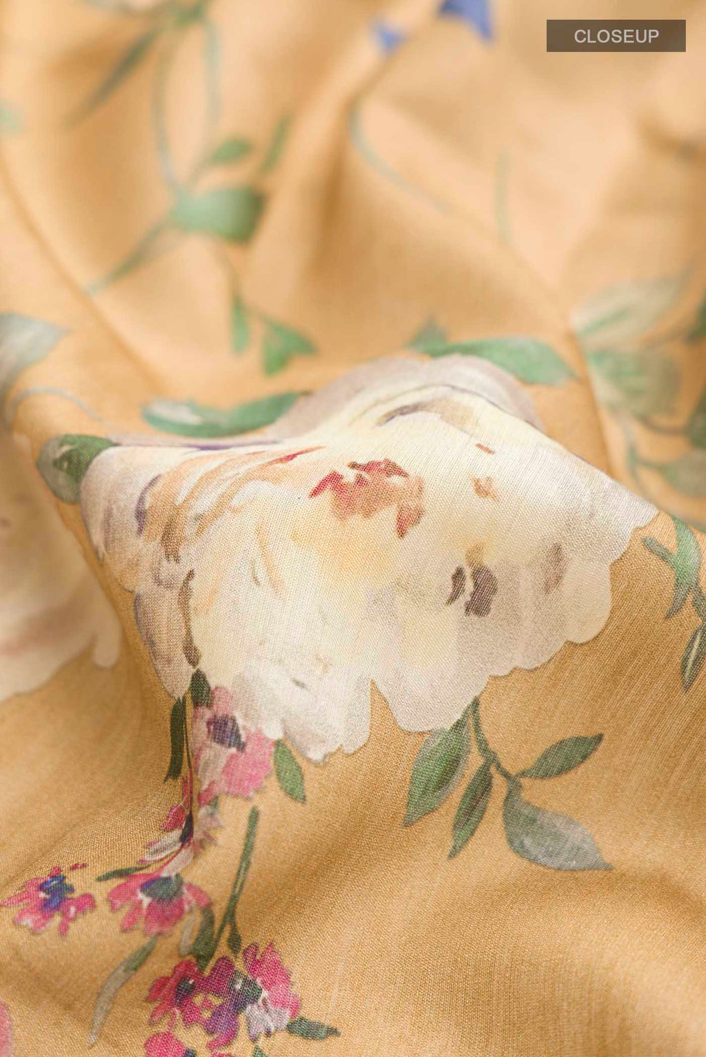 Close up of Brown Bhagalpuri Tussar Silk Saree with Floral Print on the body and Thin Zari Line displaying folds