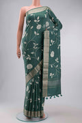 Green Tussar Silk Saree with Printed design on the body and Zari Border displayed on a mannequin
