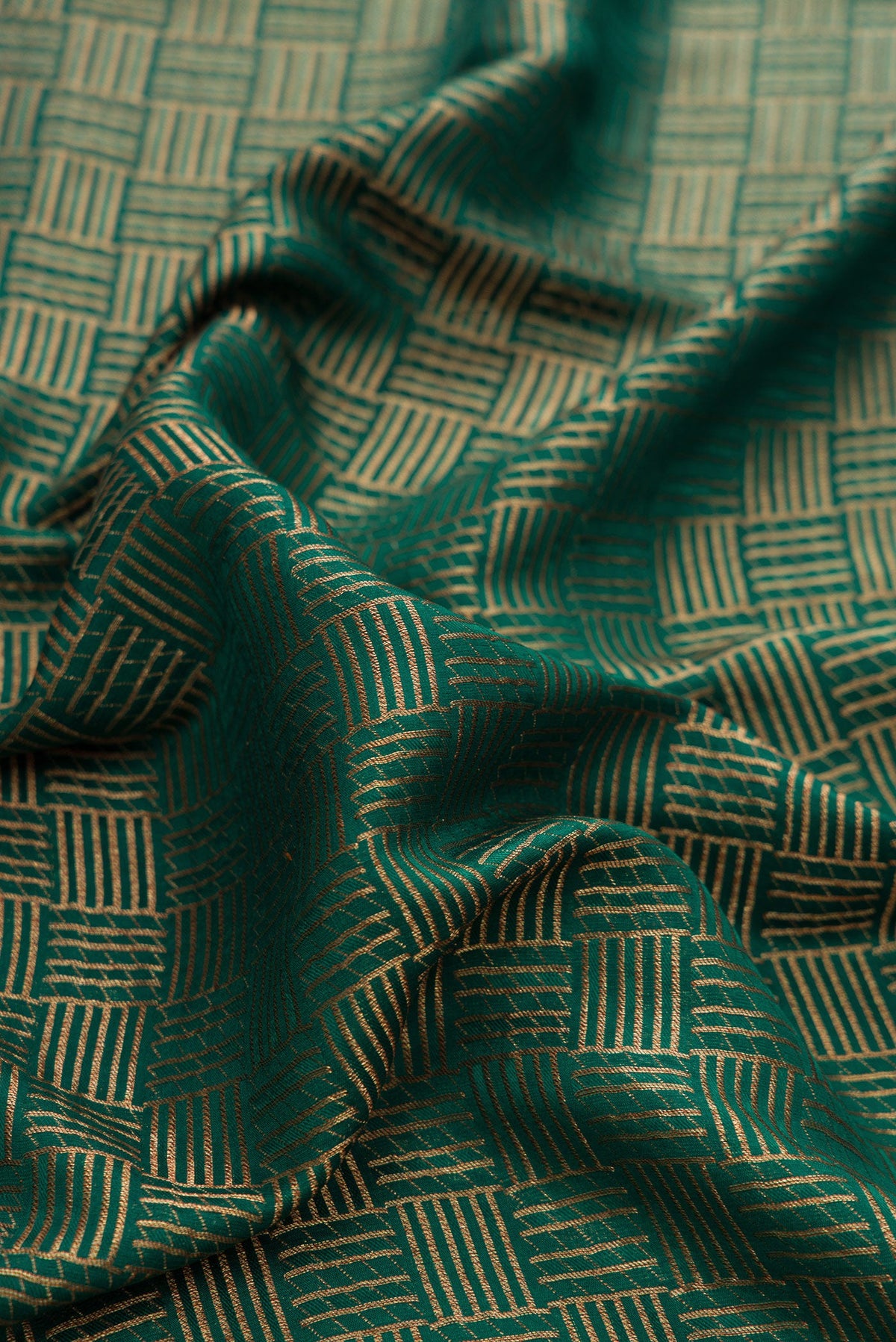 Close up of Bottle Green Dual Tone Mysore Crepe Saree with Zari Brocade on the body and Zari Border.  displaying folds
