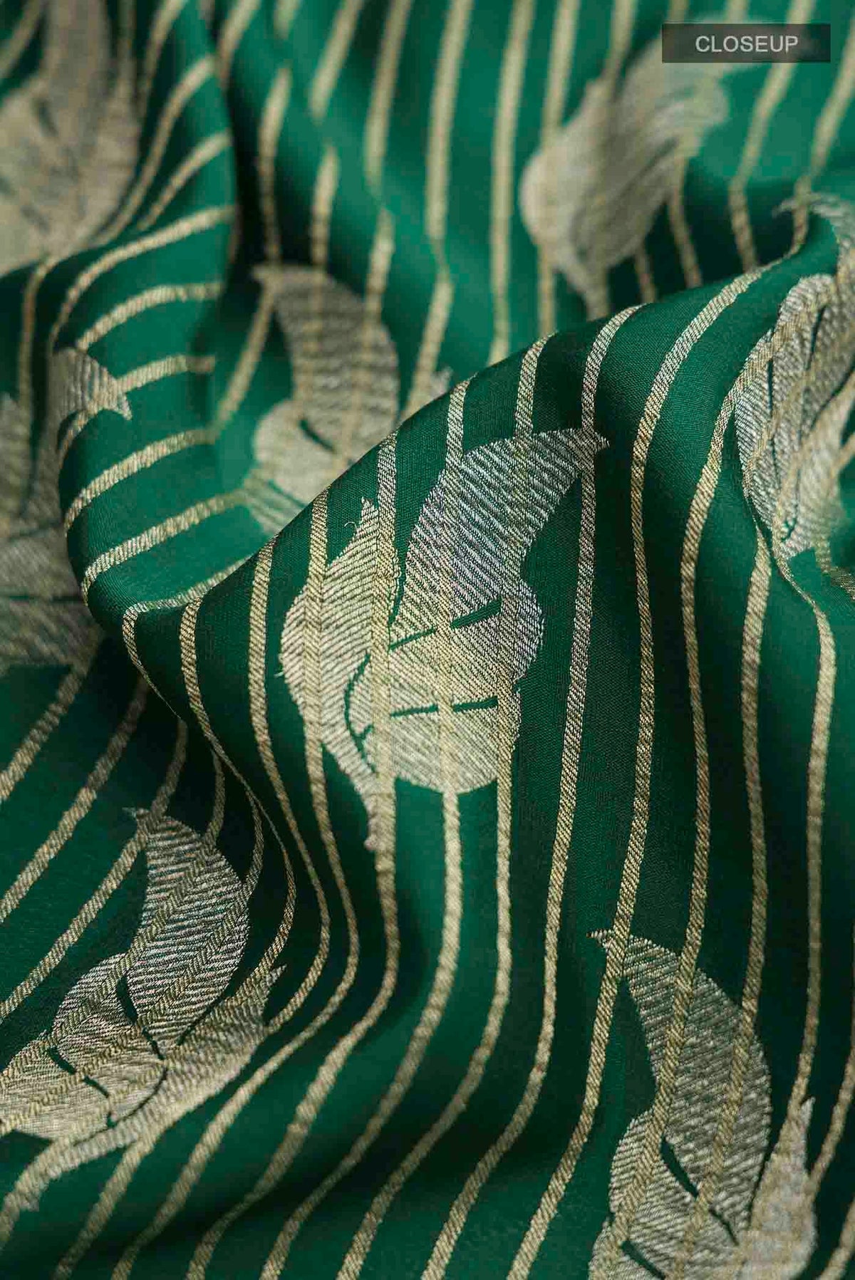 Close up of Green Mysore Crepe Saree with Zari Butta on the body and Zari Border displaying folds