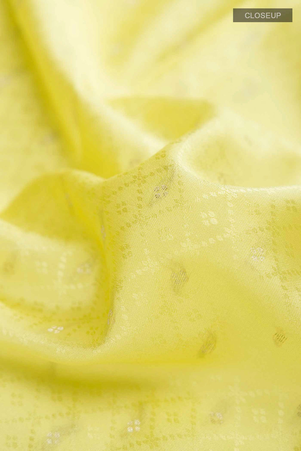 Close up of Yellow Mysore Crepe Saree with Zari Butta on the body and Zari Border displaying folds