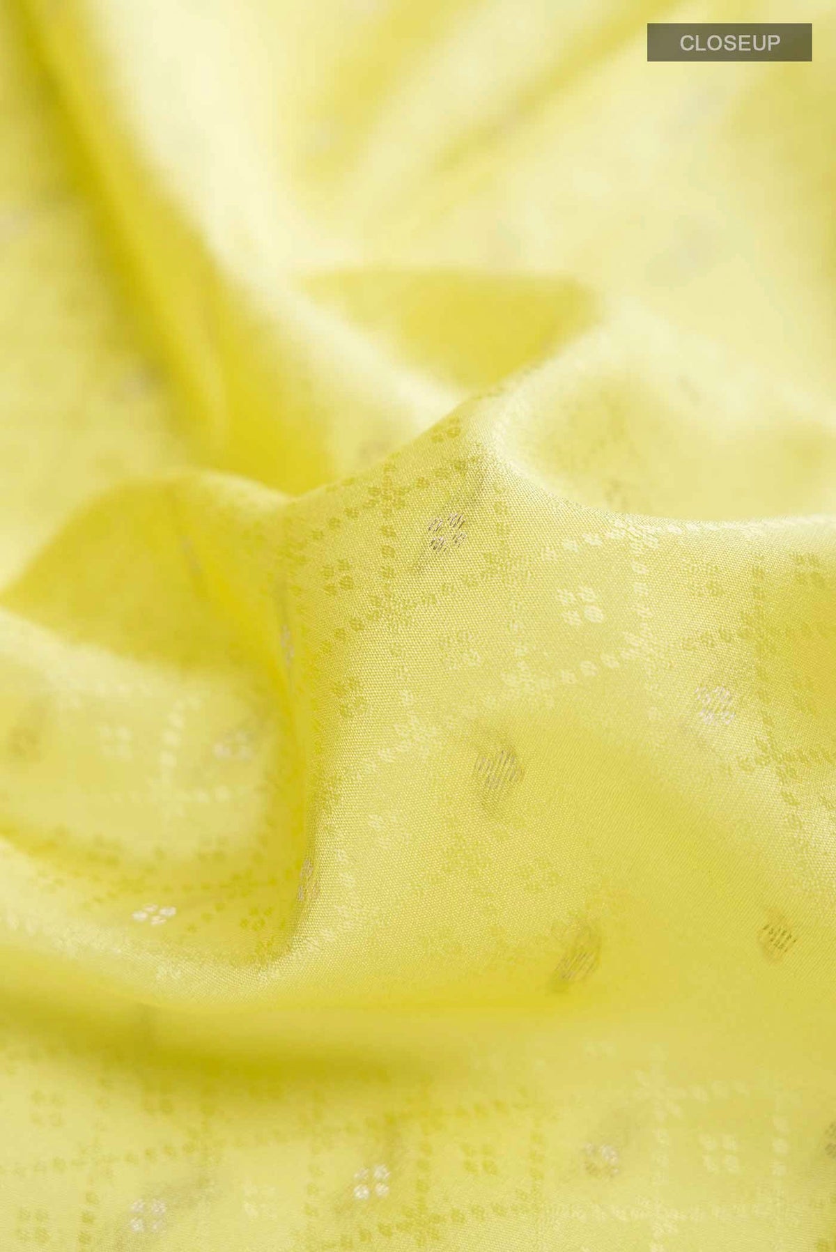 Close up of Yellow Mysore Crepe Saree with Zari Butta on the body and Zari Border displaying folds