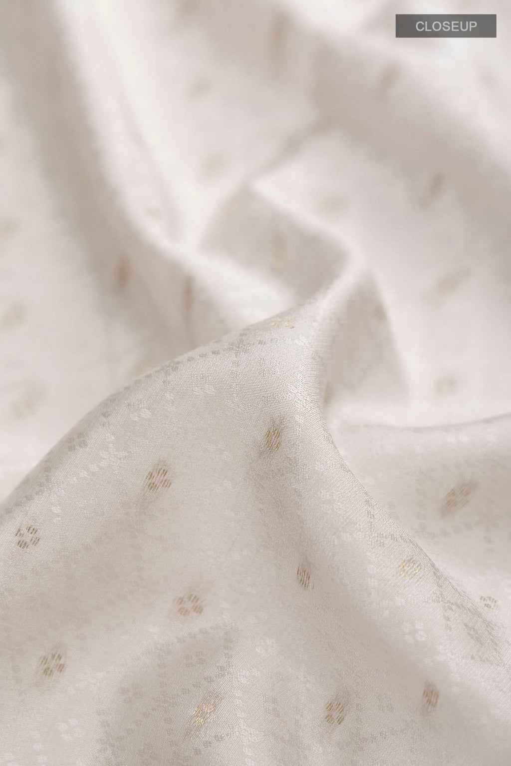 Close up of Grey Mysore Crepe Saree with Jacquard With Zari Butta on the body and Zari Border displaying folds
