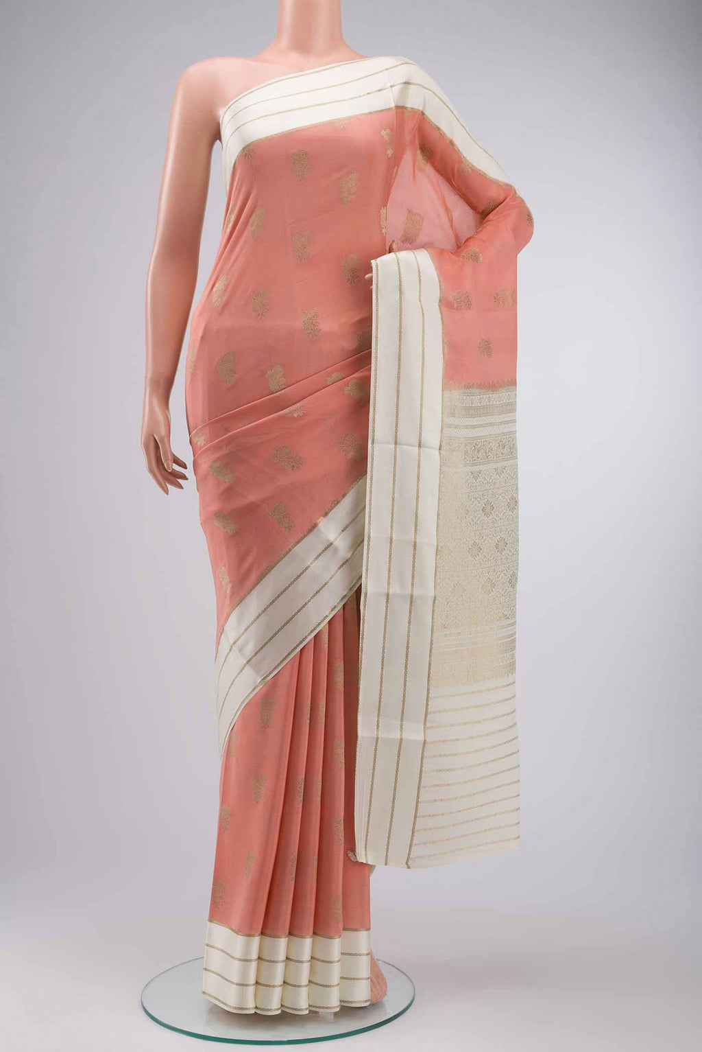 Peach Mysore Crepe Saree with Zari Butta on the body and Zari Border displayed on a mannequin