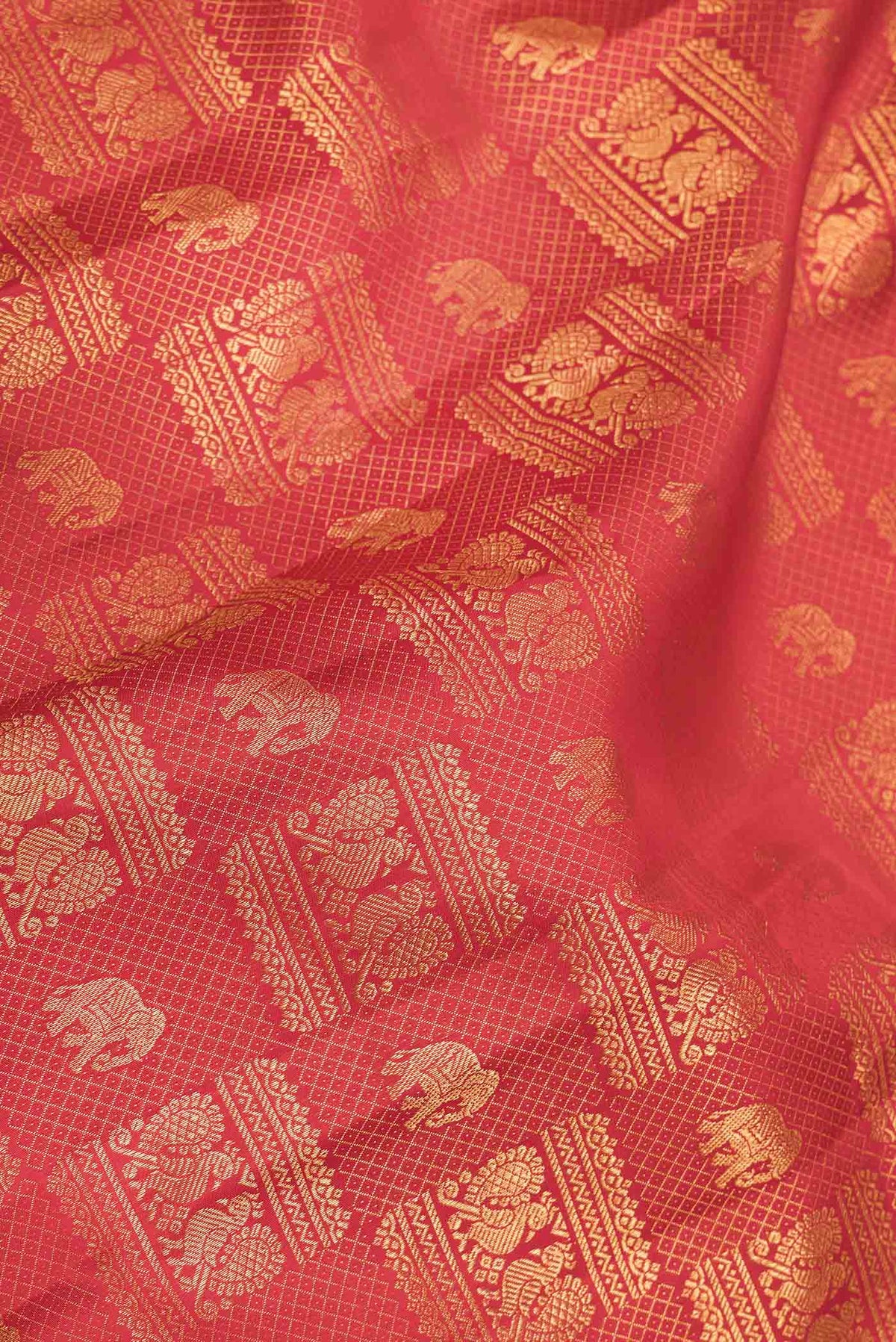 Close up of Red Dual Tone Kanchipuram Saree with Zari Brocade on the body and Zari Border displaying folds