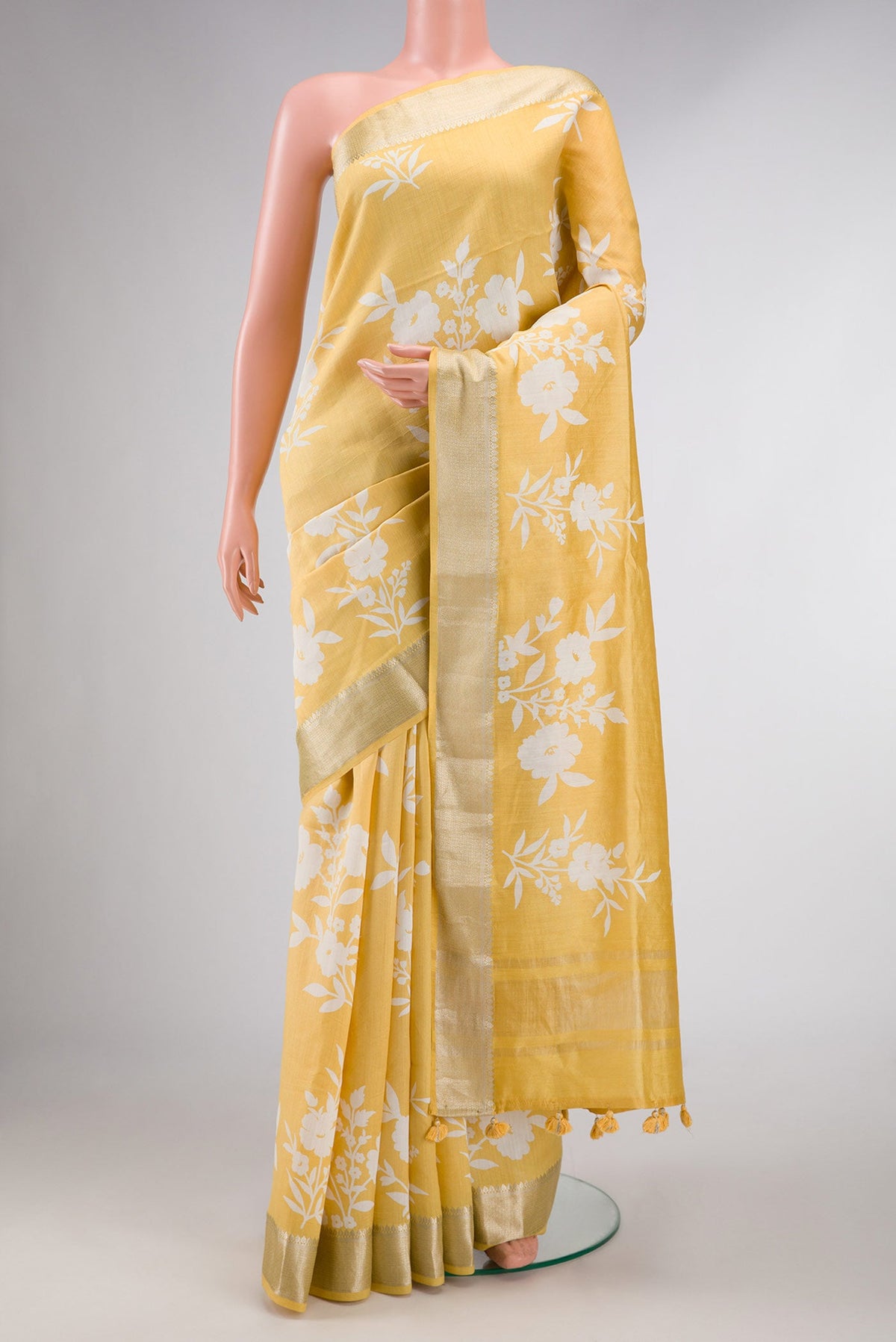 Yellow Dual Tone Tussar Silk Saree with Printed design on the body and Zari Border displayed on a mannequin