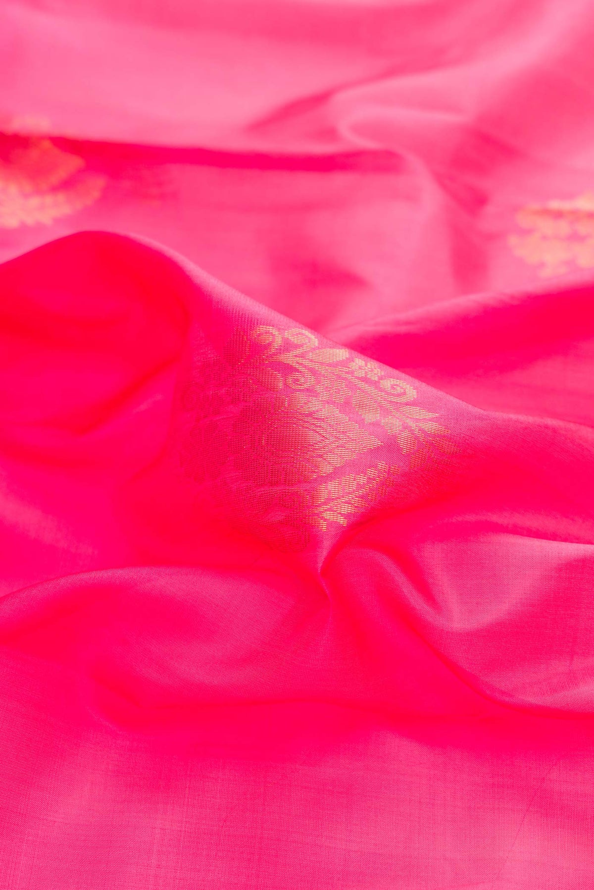 Close up of Pink Dual Tone Soft Silk Saree with Zari Butta on the body and Zari Border displaying folds