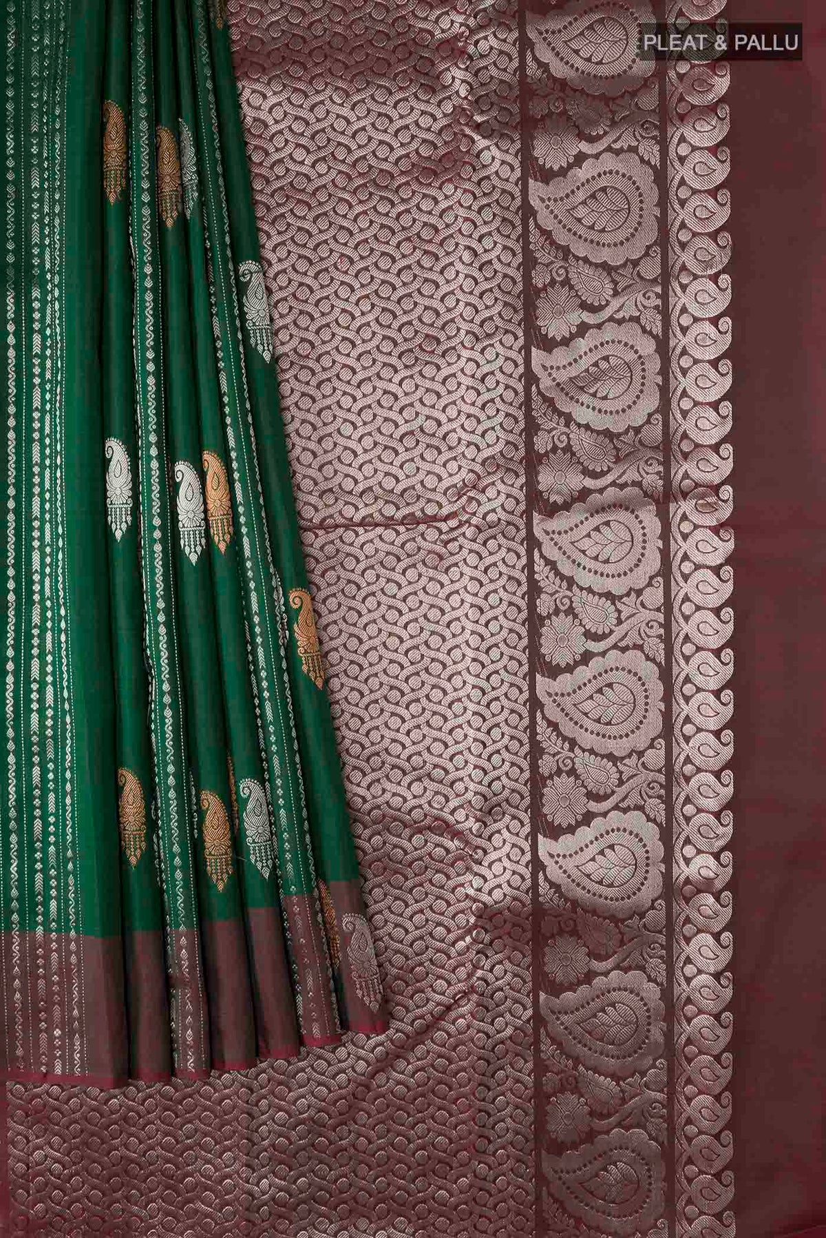 Pleats and pallu of Green Kanchipuram Silk Saree with Zari Butta on the body and Zari Border