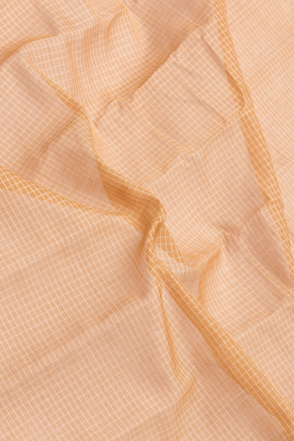 Close up of Peach Dual Tone Gadwal Silk Saree with Checked design on the body and Zari Border.  displaying folds