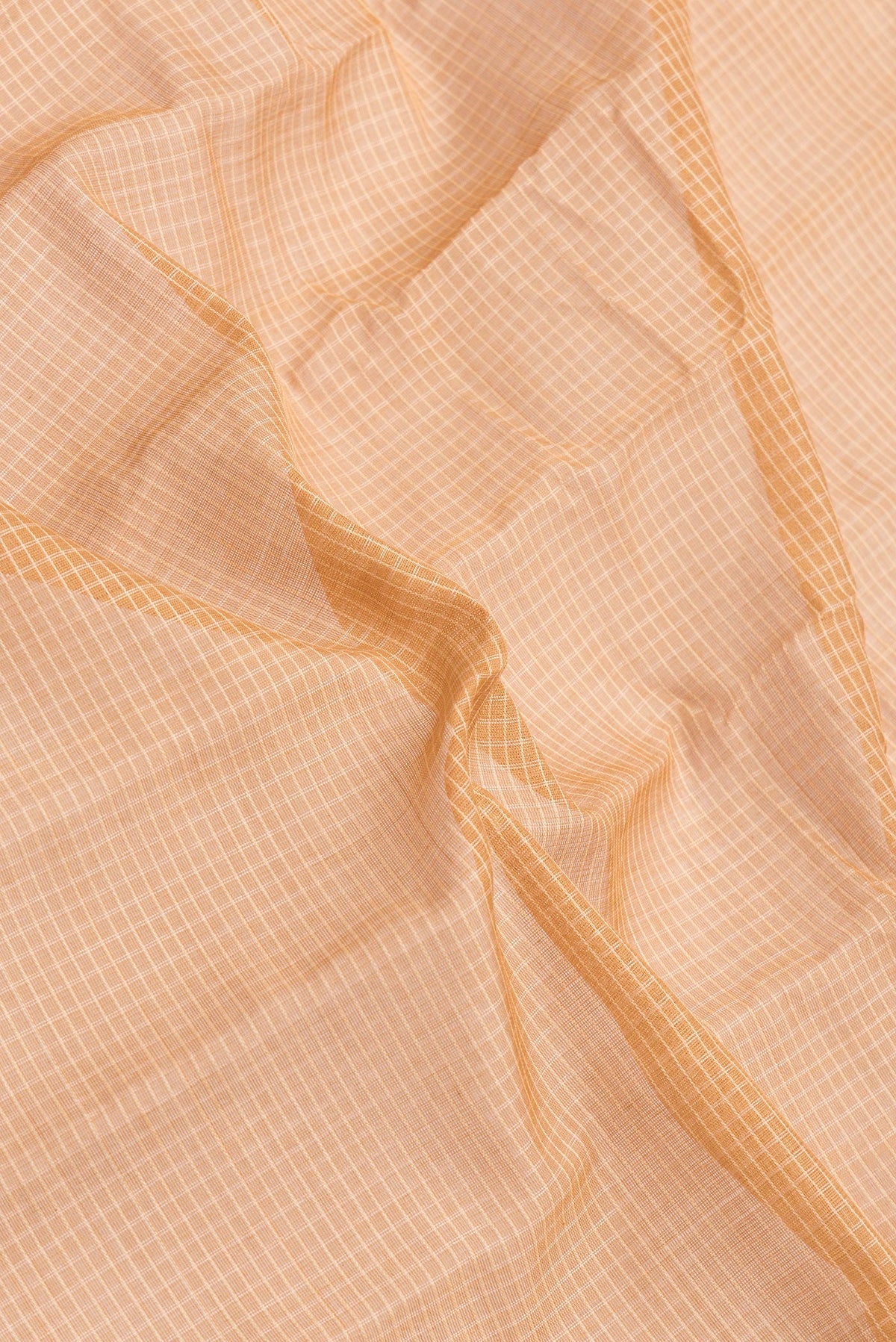 Close up of Peach Dual Tone Gadwal Silk Saree with Checked design on the body and Zari Border.  displaying folds