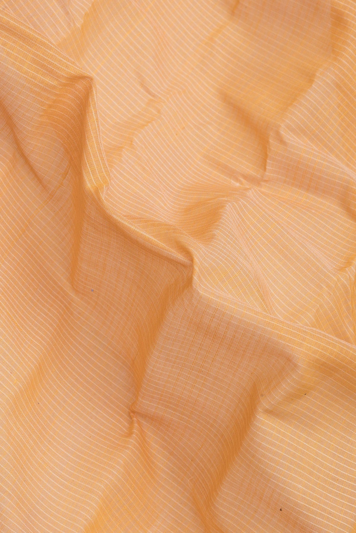 Close up of Orange Dual Tone Kanchipuram Silk Saree with Checked design on the body and Zari Border.  displaying folds