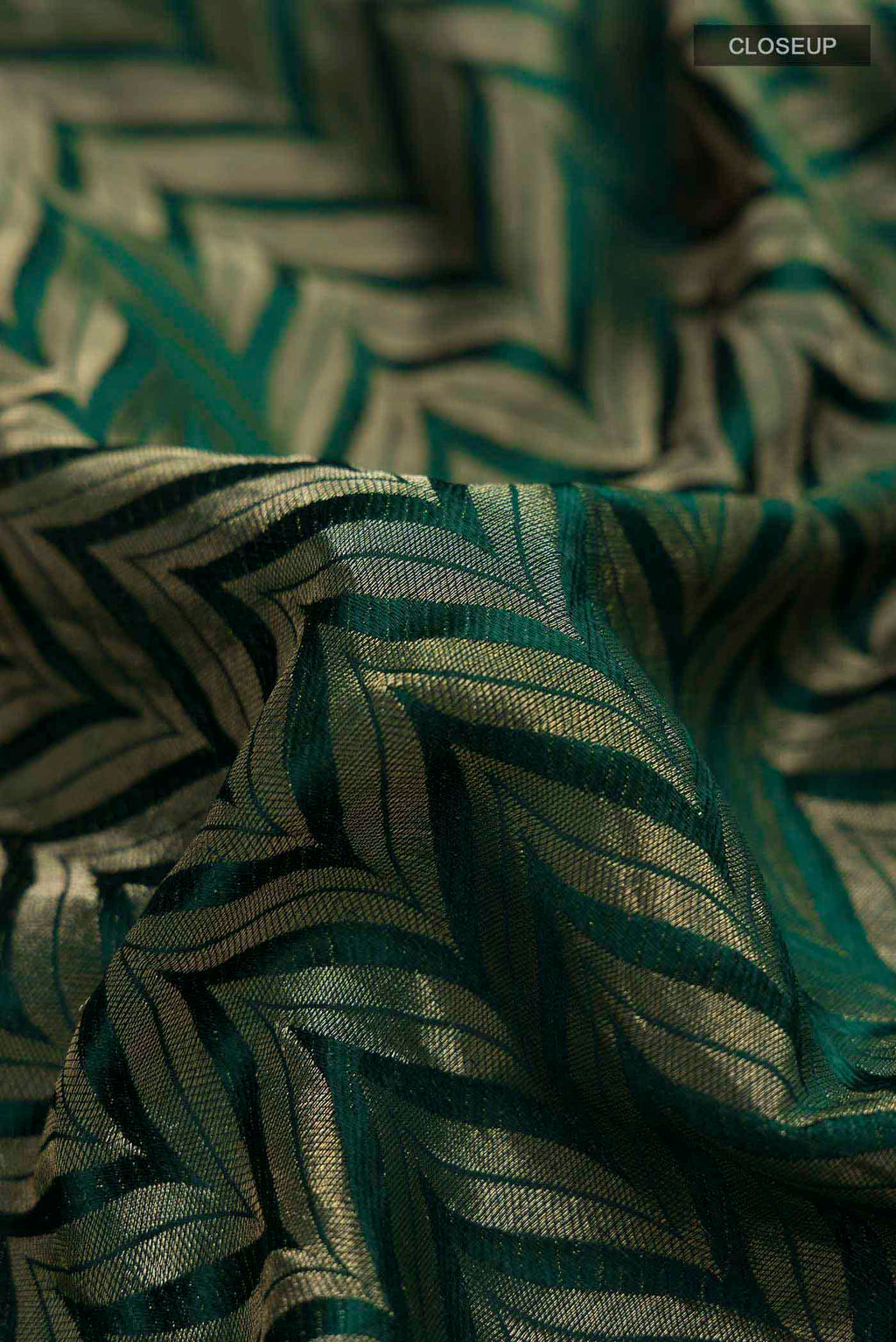 Close up of Green Mysore Crepe Saree with Zari Brocade on the body and Zari Border displaying folds