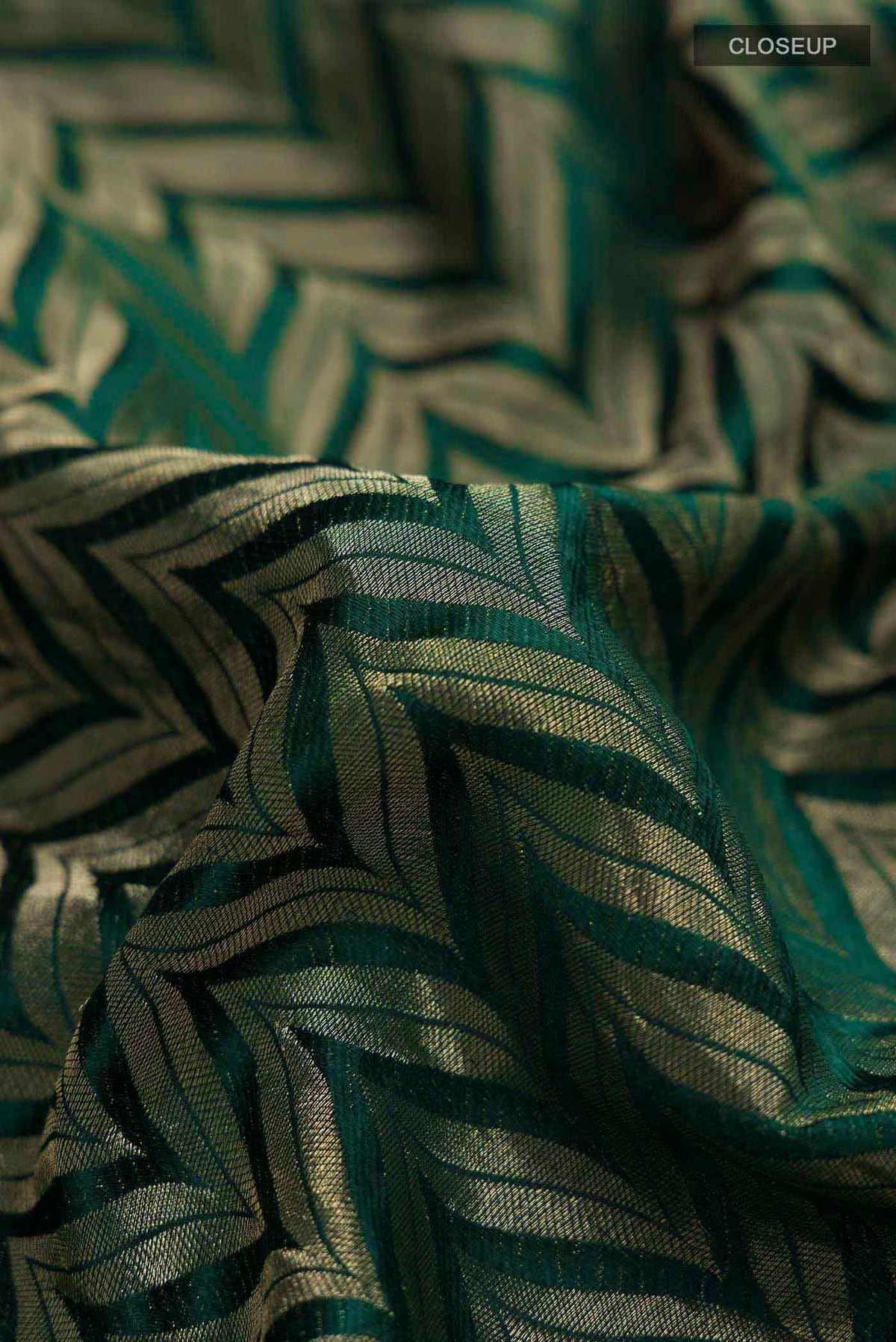 Close up of Green Mysore Crepe Saree with Zari Brocade on the body and Zari Border displaying folds