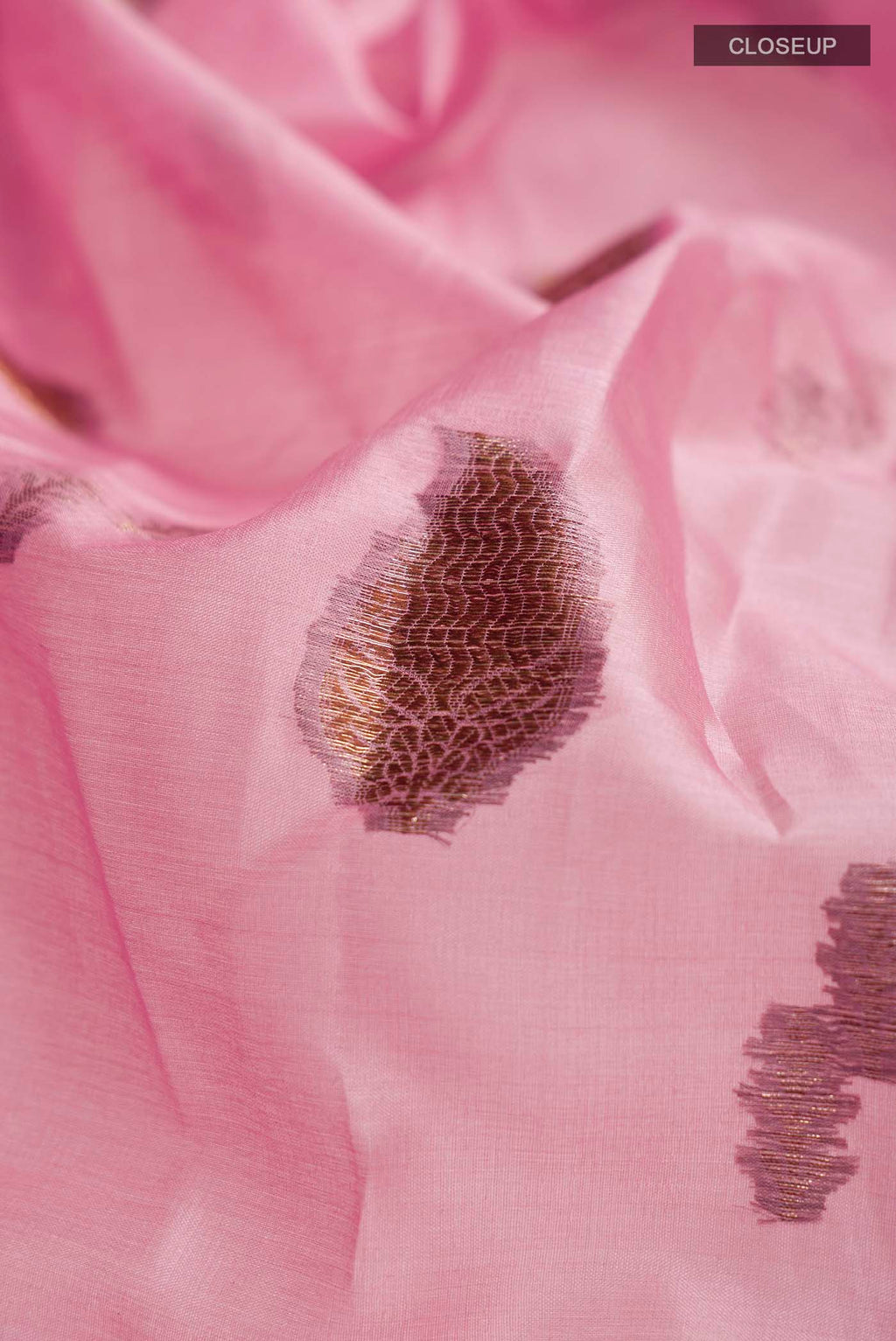 Close up of Rose pink Bhagalpuri Tussar Silk Saree with Zari Butta on the body and Zari Border displaying folds