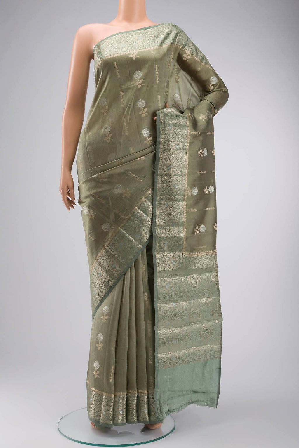 Green Banarasi Raw Silk Saree with Zari Butta on the body and Zari Border displayed on a mannequin