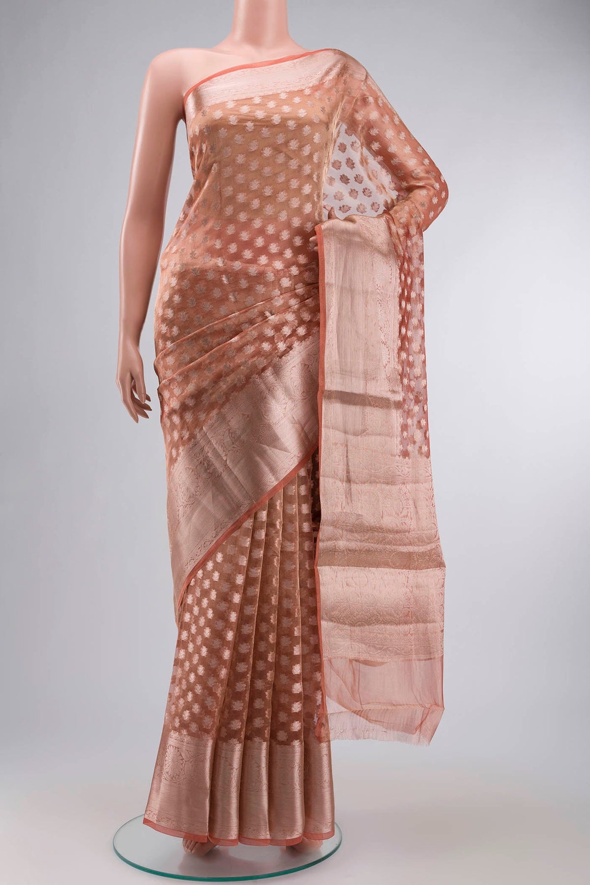 Orange Banarasi Tissue Silk Saree with Zari Butta on the body and Zari Border displayed on a mannequin