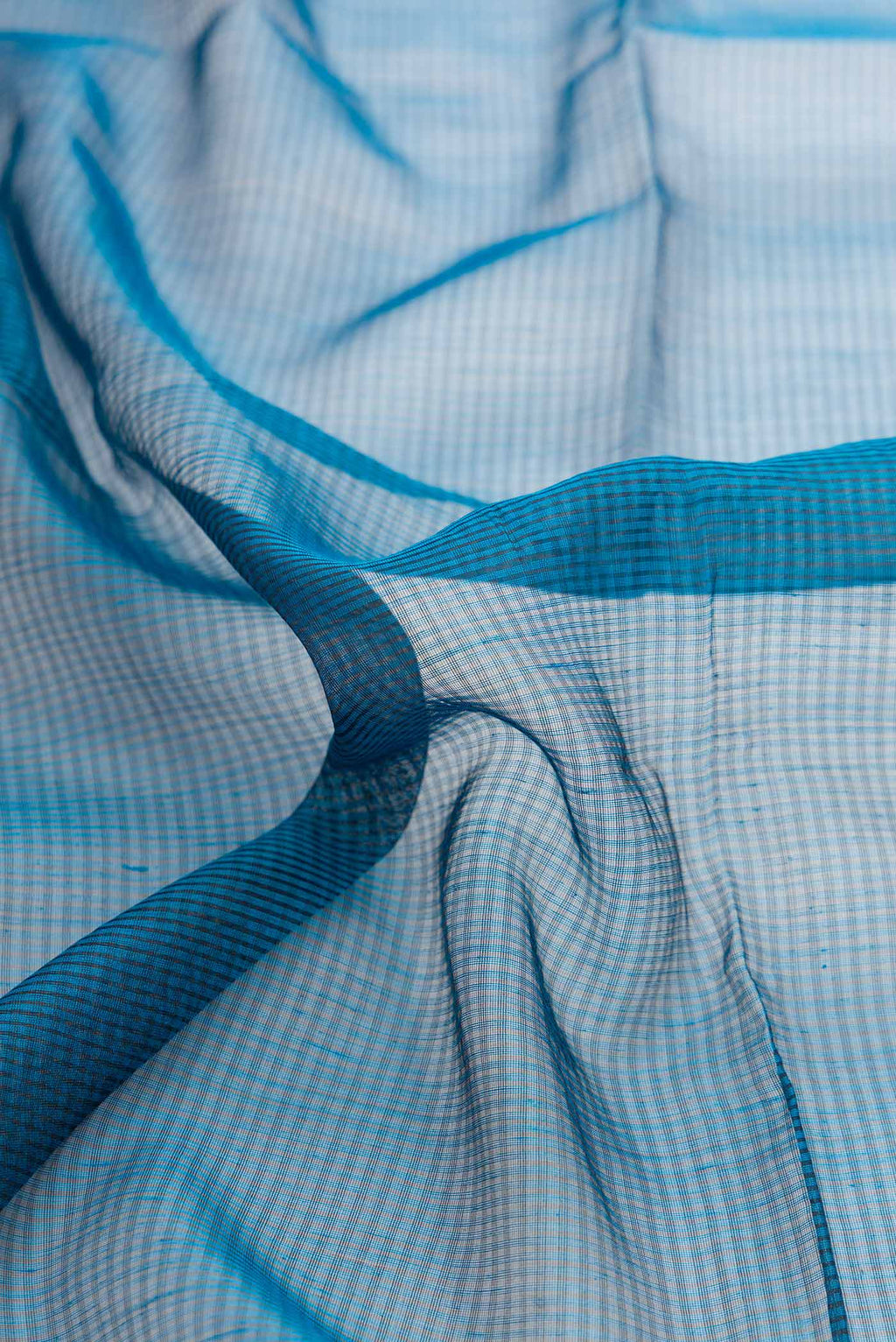 Close up of Maya Blue Dual Tone Silk Cotton Saree with Stripes on the body and Zari Border displaying folds