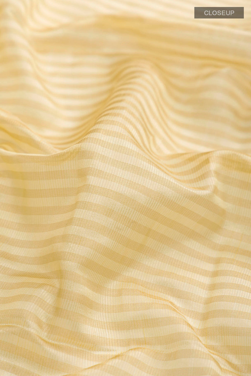 Close up of Cream Banarasi Raw Silk Saree with Stripes on the body and Zari Border displaying folds