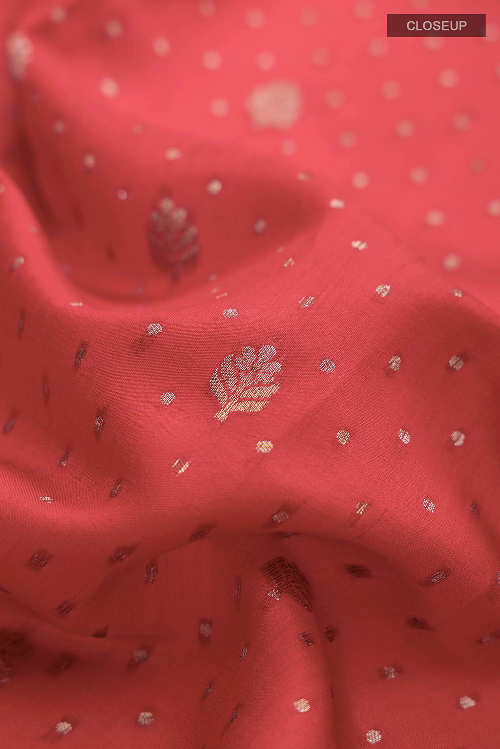 Close up of Red Raw Silk Saree with Zari Butta on the body and Zari Border displaying folds