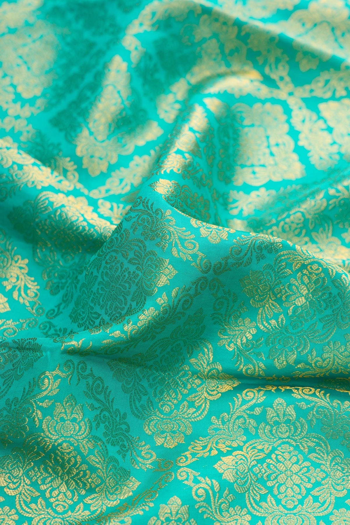 Close up of Sea Green Dual Tone Kanchipuram Silk Saree with Zari Brocade on the body and Zari Border.  displaying folds