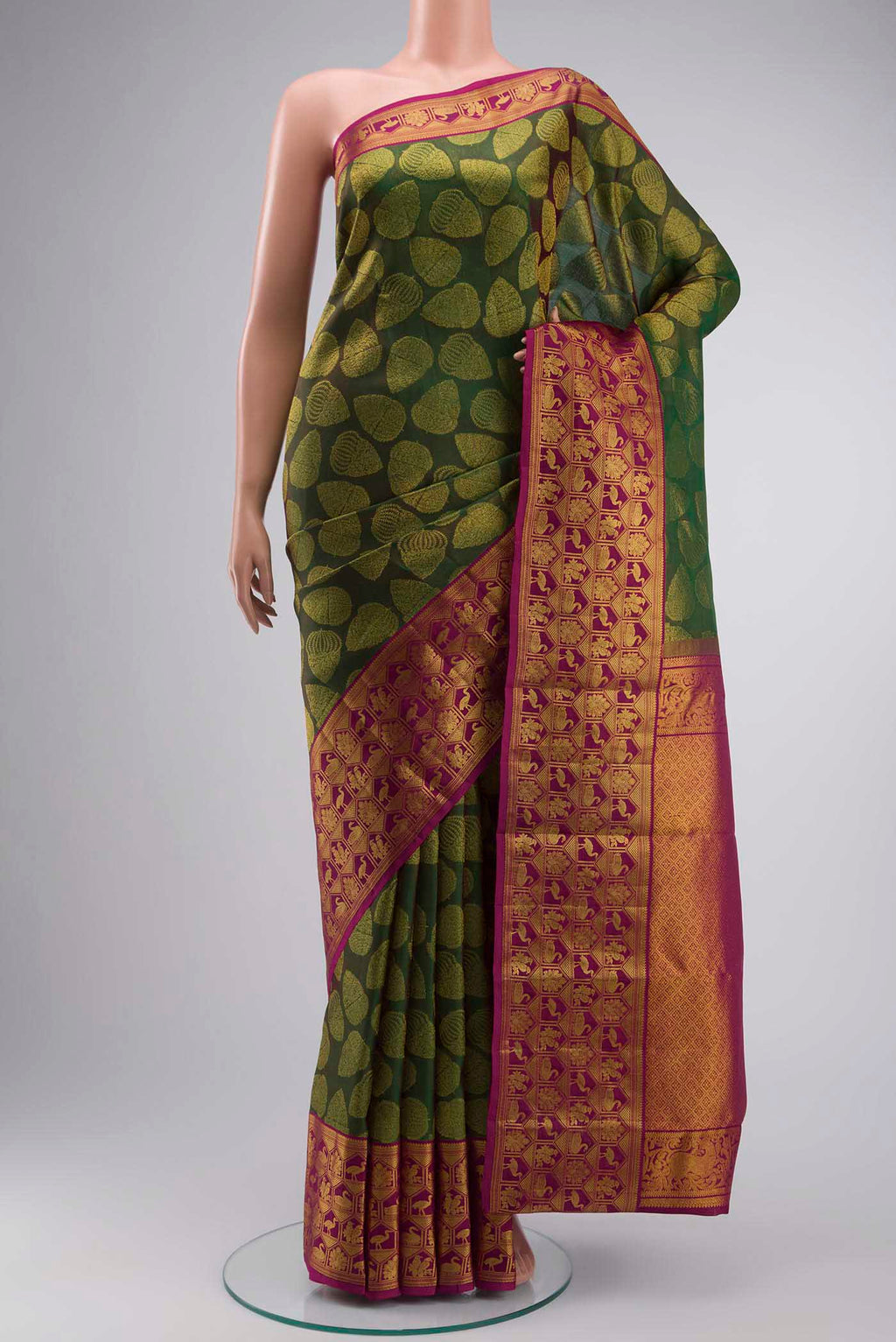 Green Kanchipuram Silk Saree with Zari Butta on the body and Zari Border displayed on a mannequin
