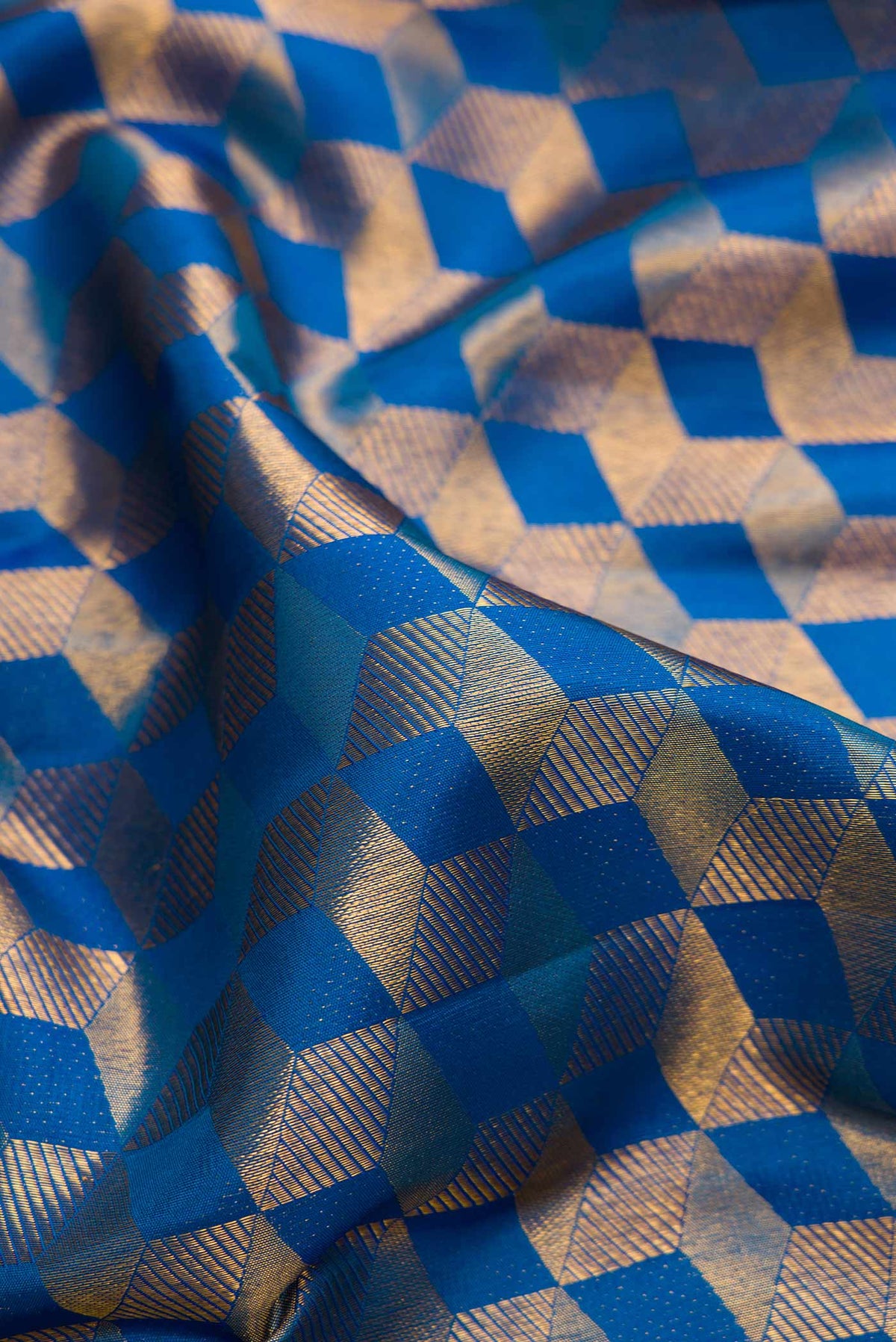 Close up of Peacock Blue Dual Tone Kanchipuram Silk Saree with Zari Brocade on the body and Zari Border.  displaying folds