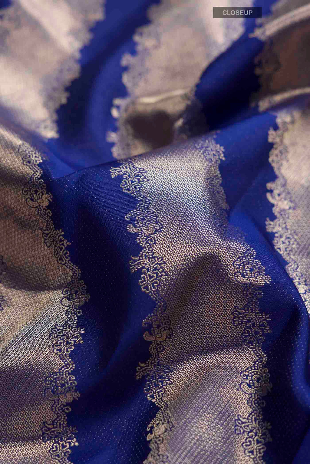 Close up of Blue Kanchipuram Silk Saree with Zari Butta on the body and Zari Border displaying folds