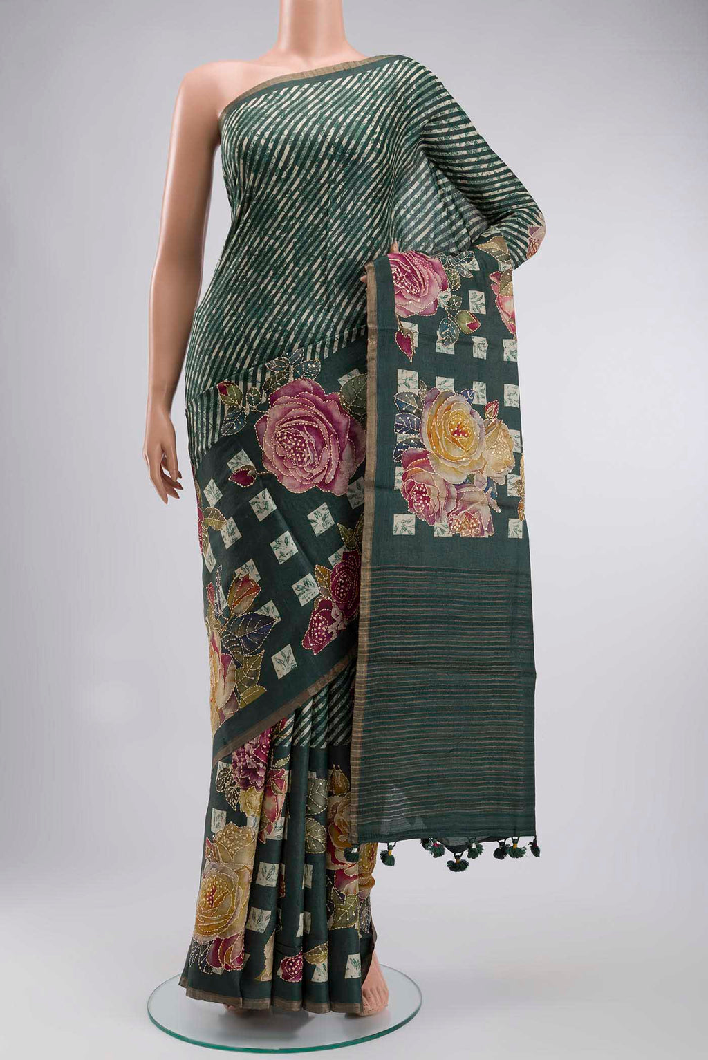 Green Tussar Silk Saree with Embroidery on the body and Zari And Thread Border displayed on a mannequin