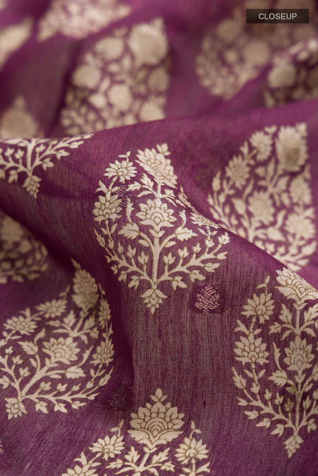 Close up of Mauve Tussar Silk Saree with Printed design on the body and Zari Border displaying folds