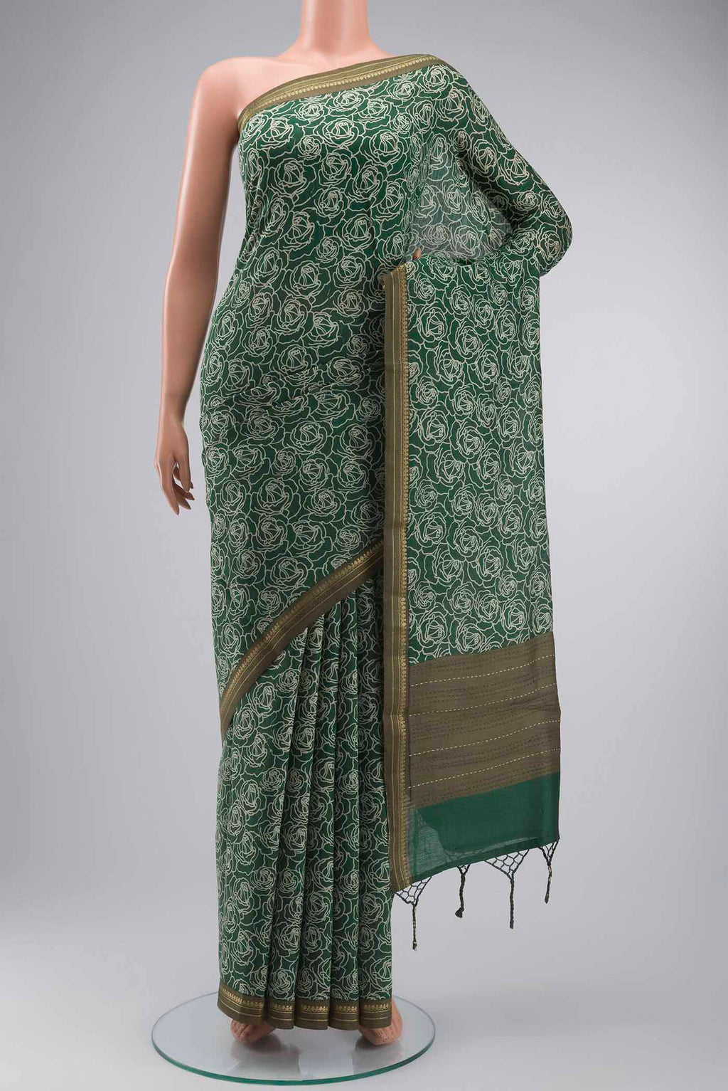 Green Tussar Silk Saree with Printed design on the body and Zari Border displayed on a mannequin