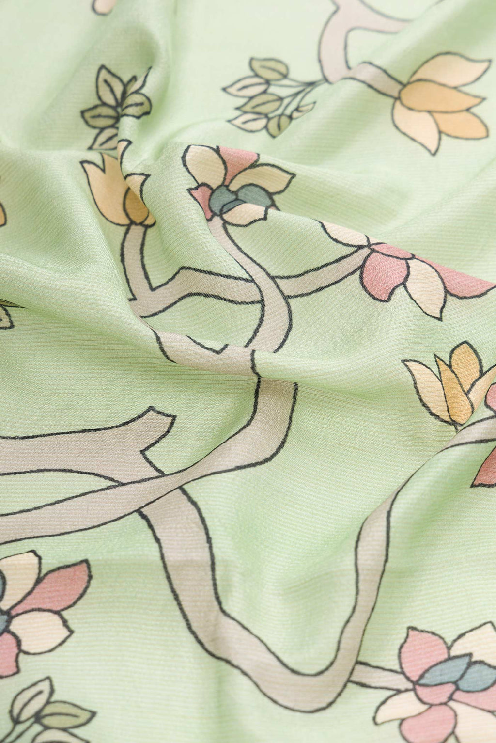 Close up of Pista Green Dual Tone Tussar Silk Saree with Printed design on the body and Fancy Border displaying folds
