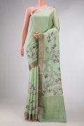 Pista Green Dual Tone Tussar Silk Saree with Printed design on the body and Fancy Border displayed on a mannequin