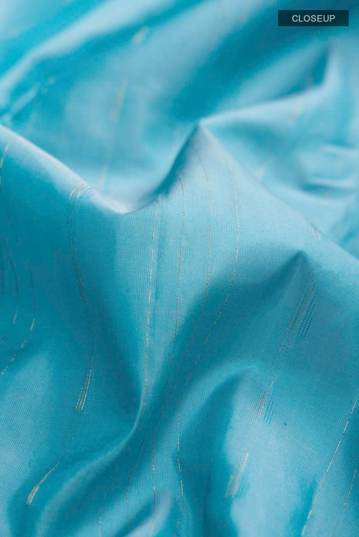 Close up of Blue Kanchipuram Silk Saree with Zari Butta on the body and Zari Border displaying folds