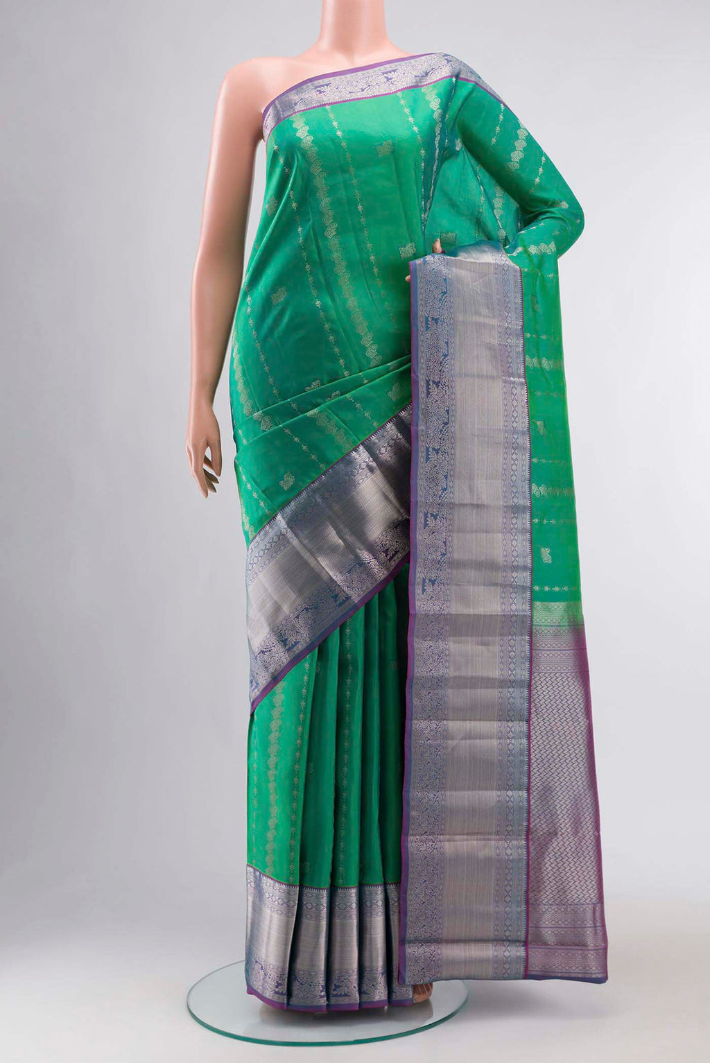 Green Kanchipuram Silk Saree with Zari Butta on the body and Zari Border displayed on a mannequin