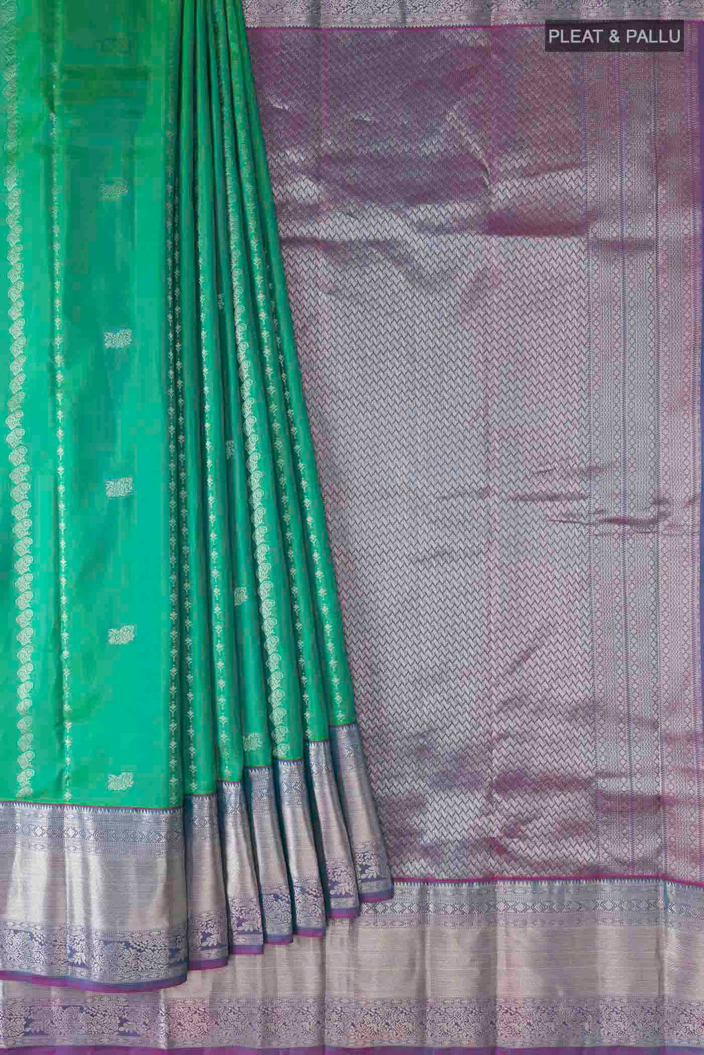 Pleats and pallu of Green Kanchipuram Silk Saree with Zari Butta on the body and Zari Border