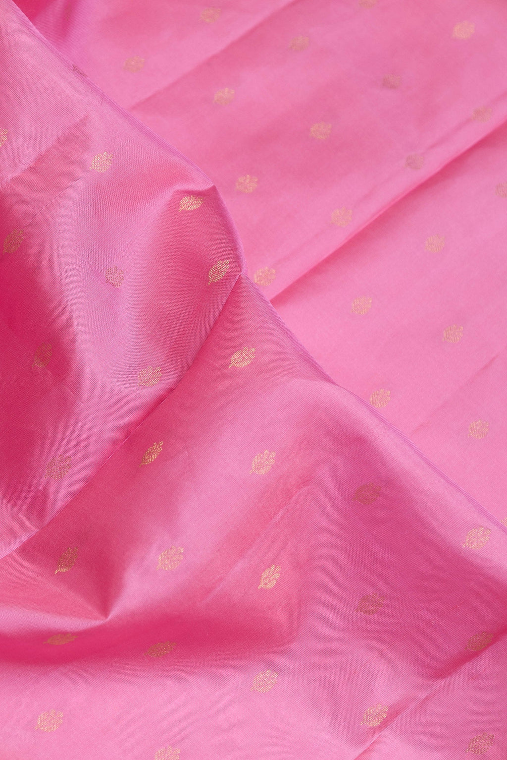 Close up of Pink Dual Tone Kanchipuram Silk Saree with Zari Butta on the body and Fancy Border.  displaying folds