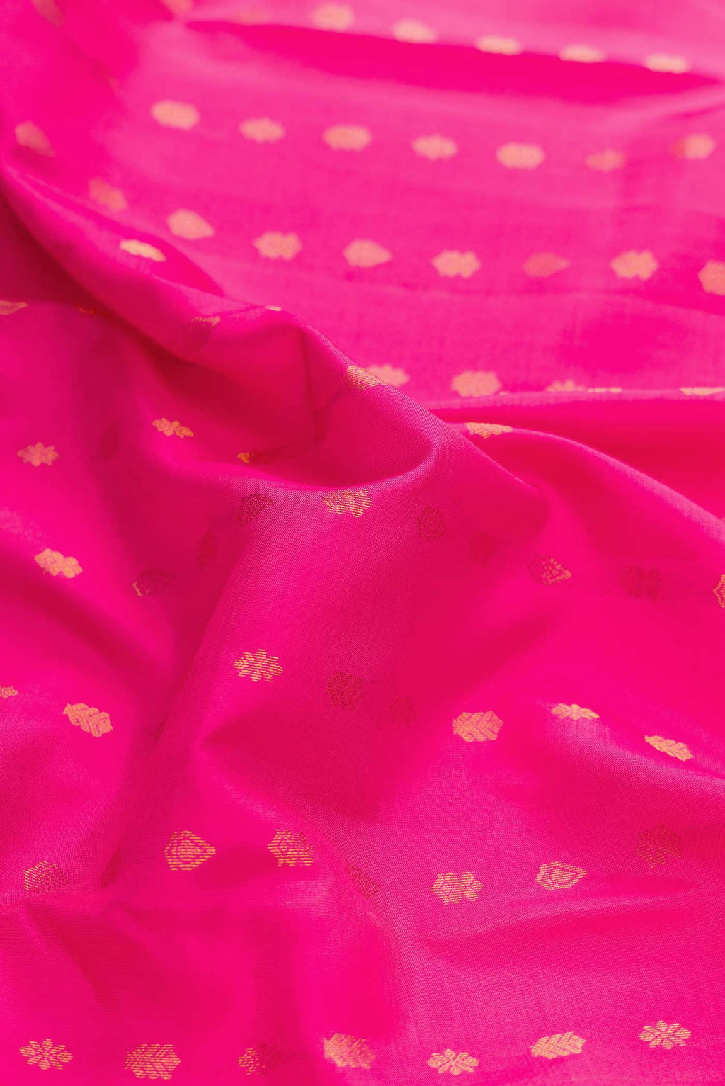 Close up of Pink Dual Tone Kanchipuram Silk Saree with Zari Butta on the body and Zari Border displaying folds