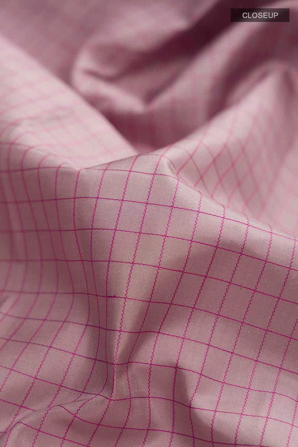 Close up of Mauve Kanchipuram Silk Saree with Checked design on the body and Zari Border displaying folds