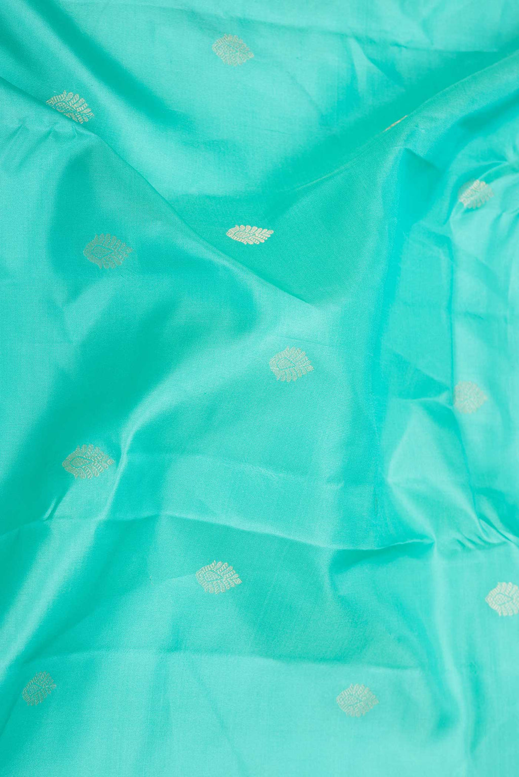 Close up of Sea Green Dual Tone Kanchipuram Saree with Zari Butta on the body and Zari Border displaying folds