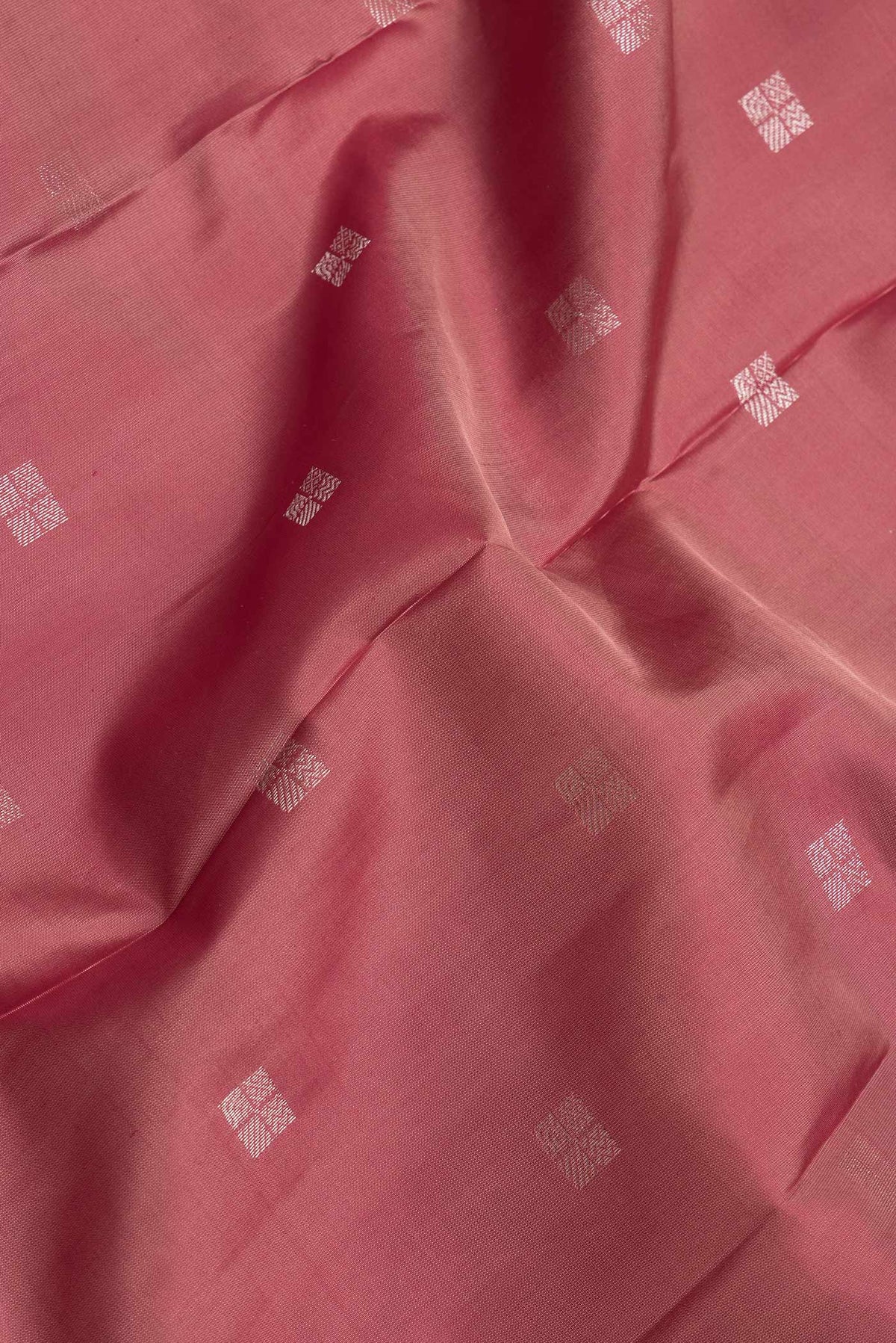 Close up of Brown Dual Tone Kanchipuram Silk Saree with Zari Butta on the body and Zari Border.  displaying folds