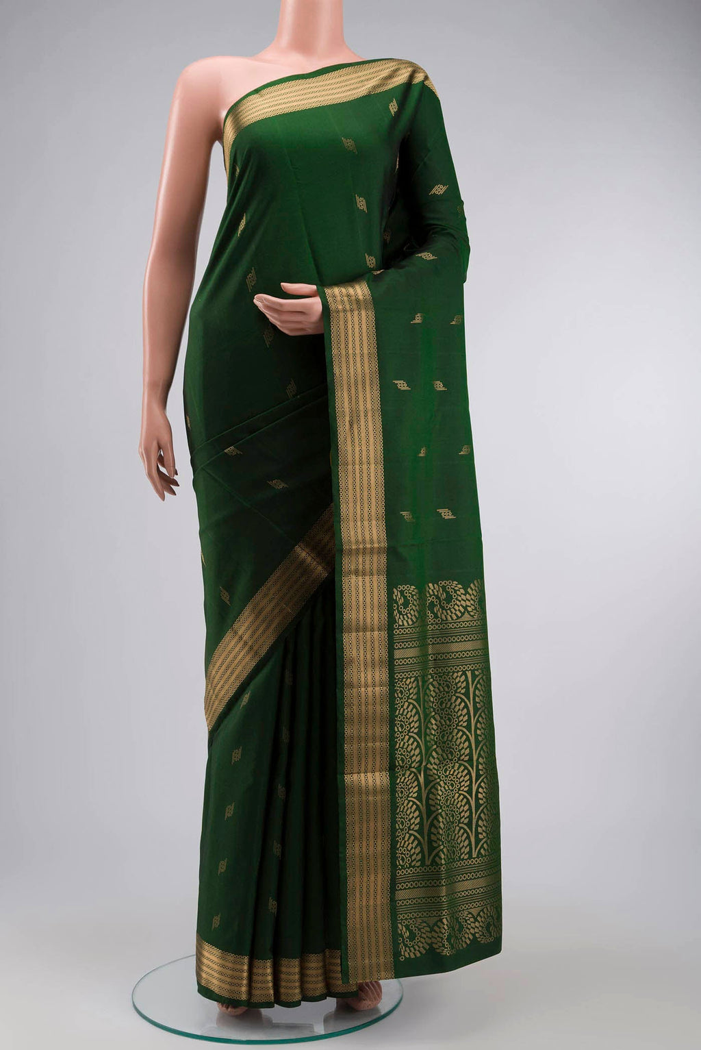 Green Soft Silk Saree with Zari Butta on the body and Zari Border displayed on a mannequin
