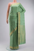 Green Soft Silk Saree with Zari Butta on the body and Zari Border displayed on a mannequin